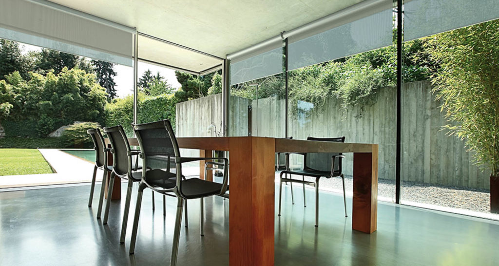 With the walls of floor-to-ceiling windows in this dining space, motorized window treatments enable fine-grained control over daylighting, privacy, and solar heat gain. Image: Nice Group USA.