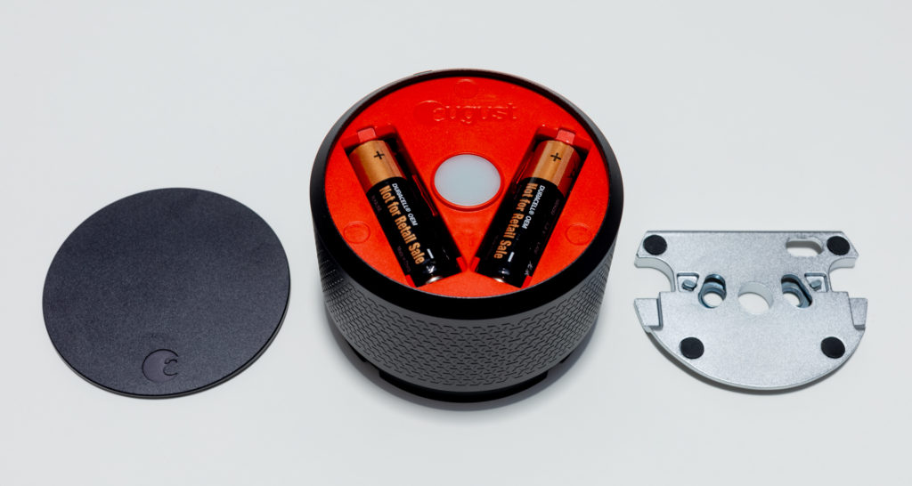 A set of four AA batteries power the August Smart Lock Pro and reside behind the magnetic faceplate. A cast metal mounting plate attaches to the door. Image: Digitized House.