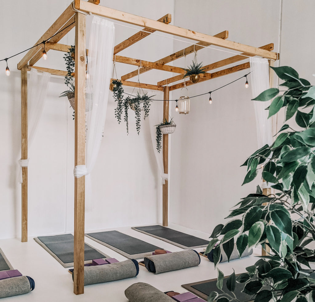 Not your average yoga space, this setup embraces elements from nature in the use of special fabrics and plants. Image: Tiff Ng from Pexels.