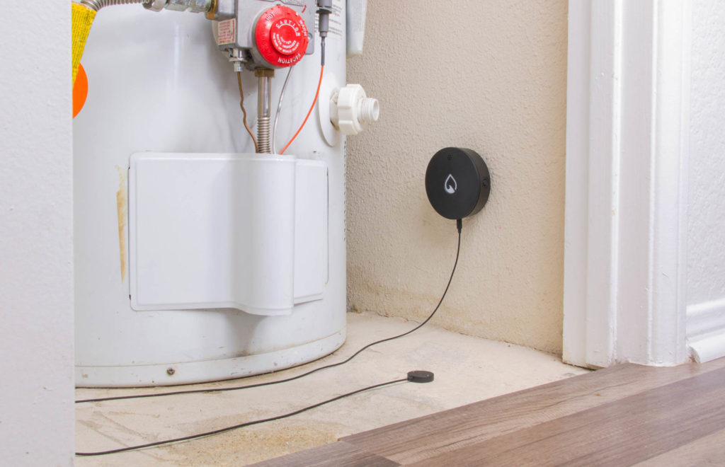 A wall-mounted Phyn Smart Water Sensor fitted with the accessory Extension Node to monitor a water heater. Image: Phyn.